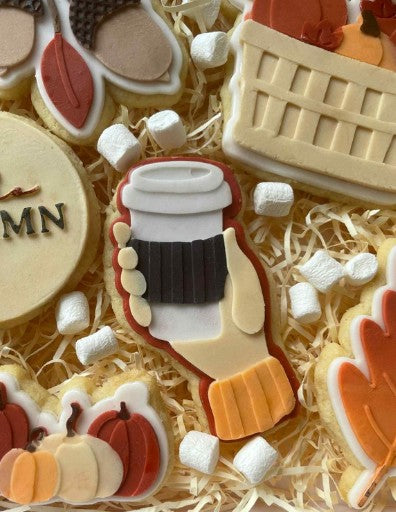 Hand with coffee cup cookie cutter and stamp