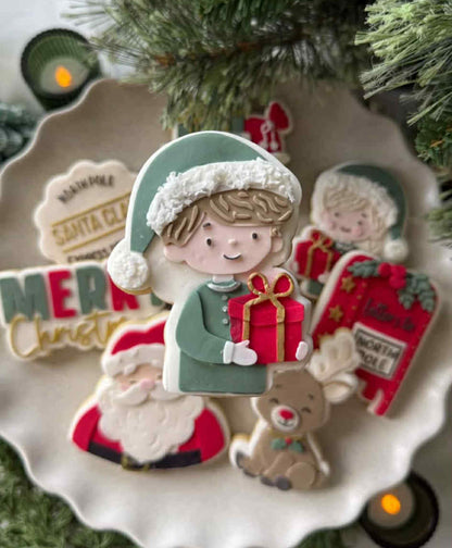 Boy holding present cookie cutter and stamp
