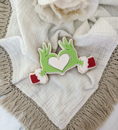 Hands making a heart cookie cutter and stamp