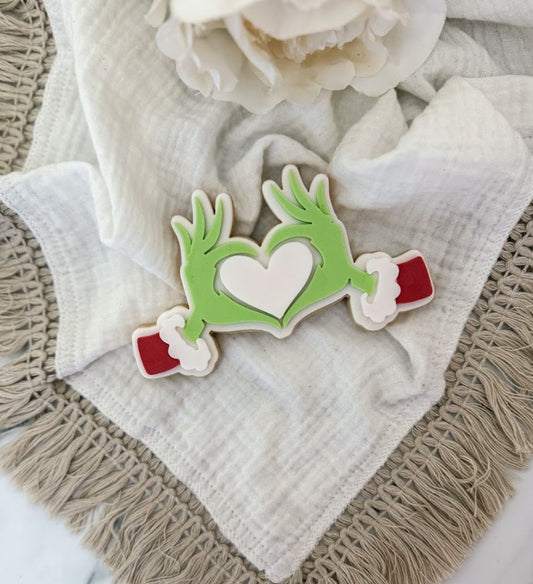 Hands making a heart cookie cutter and stamp